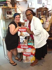 Portia Sam and friend with stack of Huggies diapers