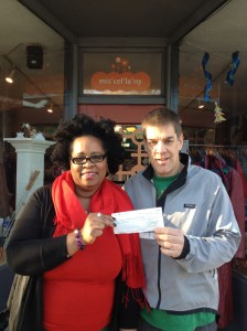 Warren Bentz from OddFellows giving Portia Sam a cheque